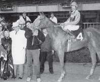 Bob Lippman (in white coat with Norma beside him) enjoys the winner's circle in May 1988 with Producer's Couch, a half-sister to Big Brown Eyes, ridden by Mike Venezia.