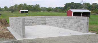 The finished manure storage pit was designed with the help of NRCS. Click to see a close-up of the drainage spaces at the bottom of the pit.